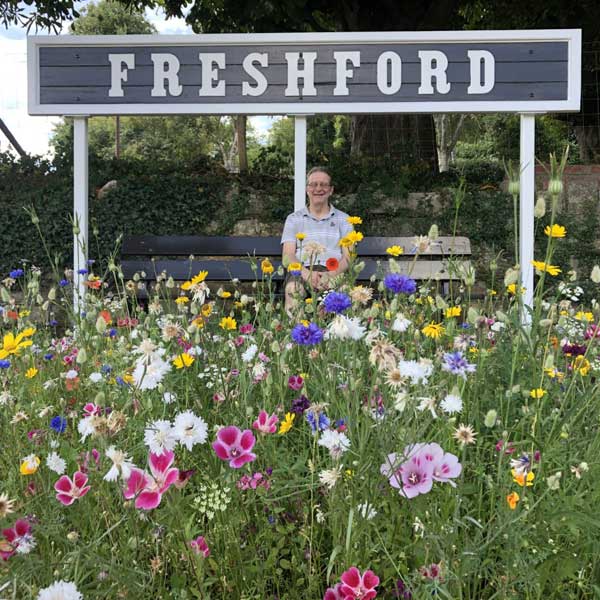 Summer flowers at a rural train station.